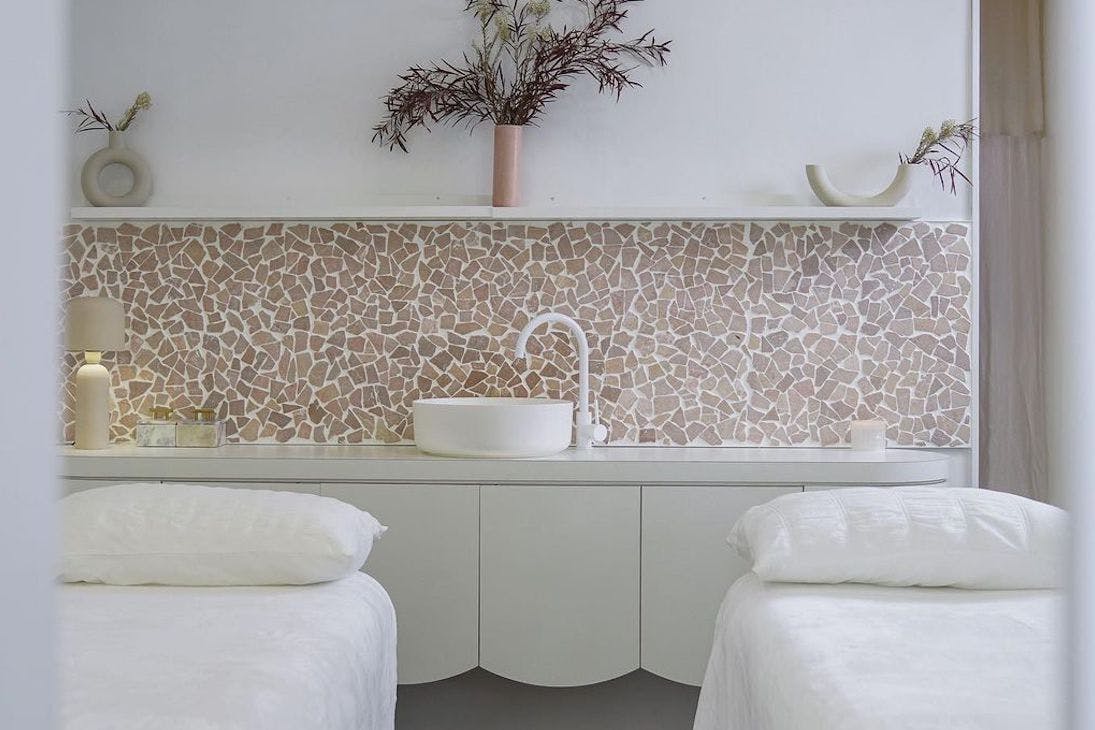 two massage beds in a Perth day spa room with pink-hued tiles
